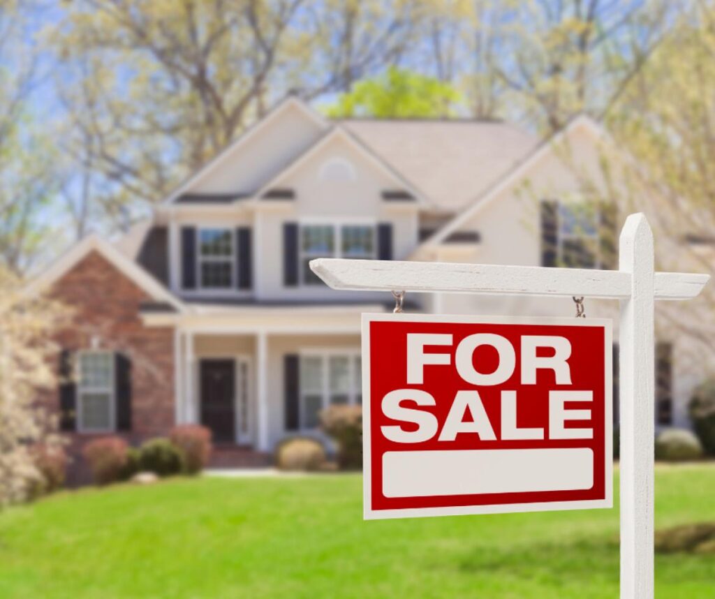 house with For Sale sign in yard