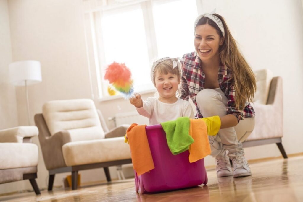 woman and child with cleaning supplies